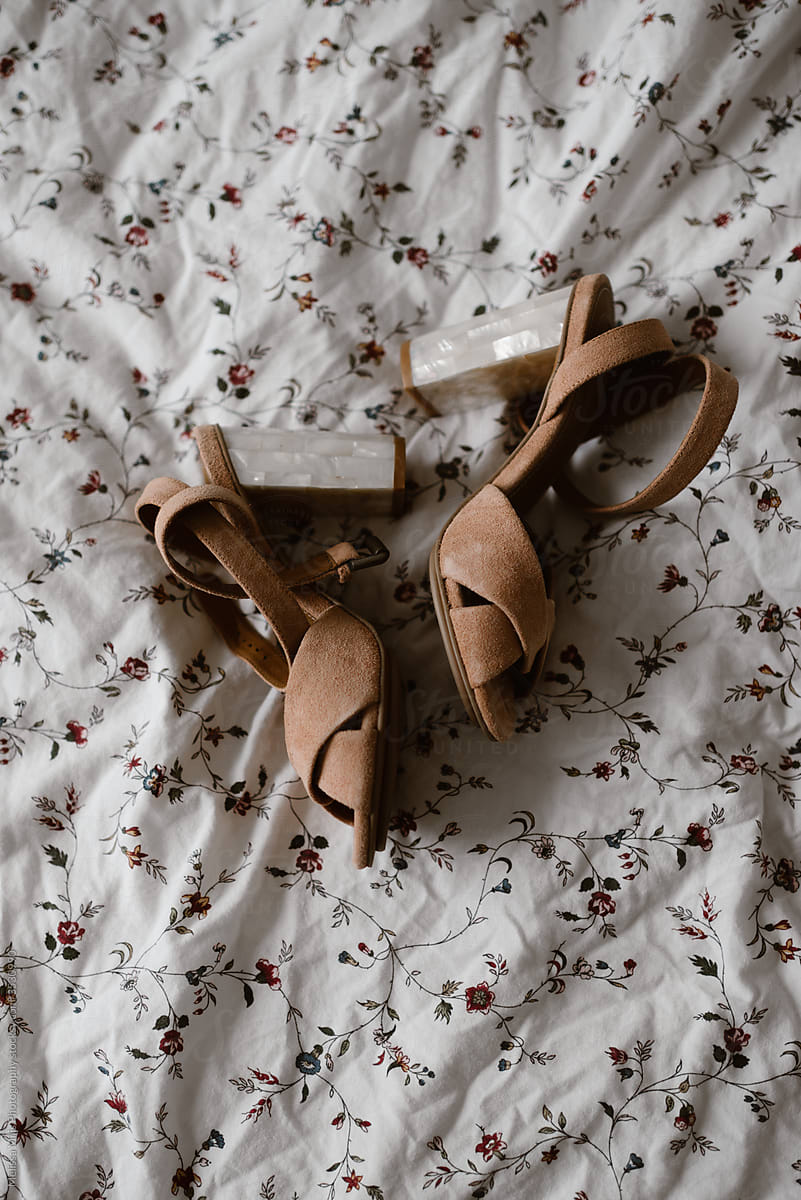 Pink blush shoes with high heels on bed