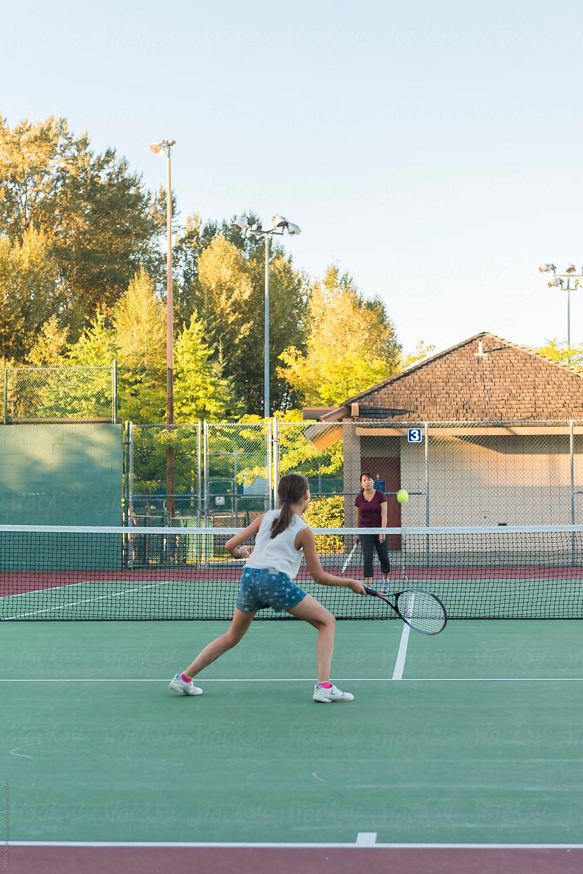 Mother And Daughter Playing Tennis