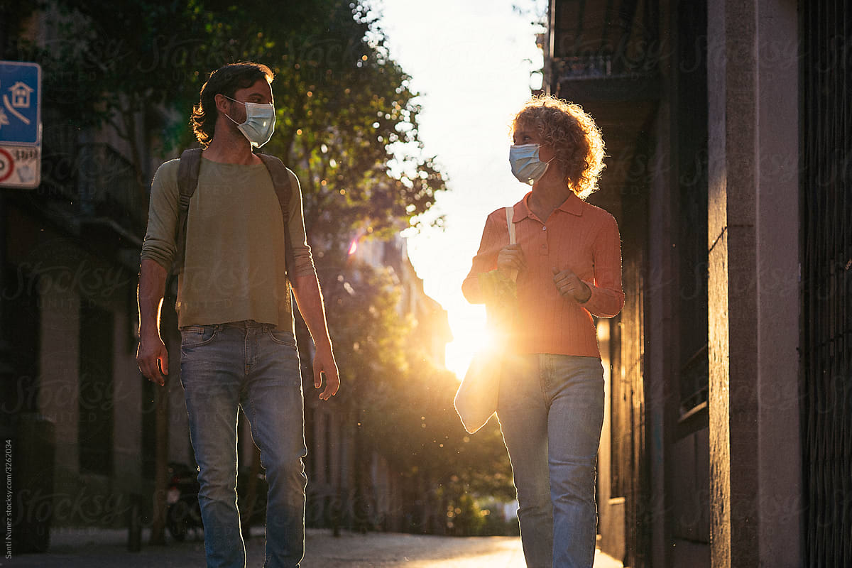 Front View of Friends With Face Masks Talking in Street