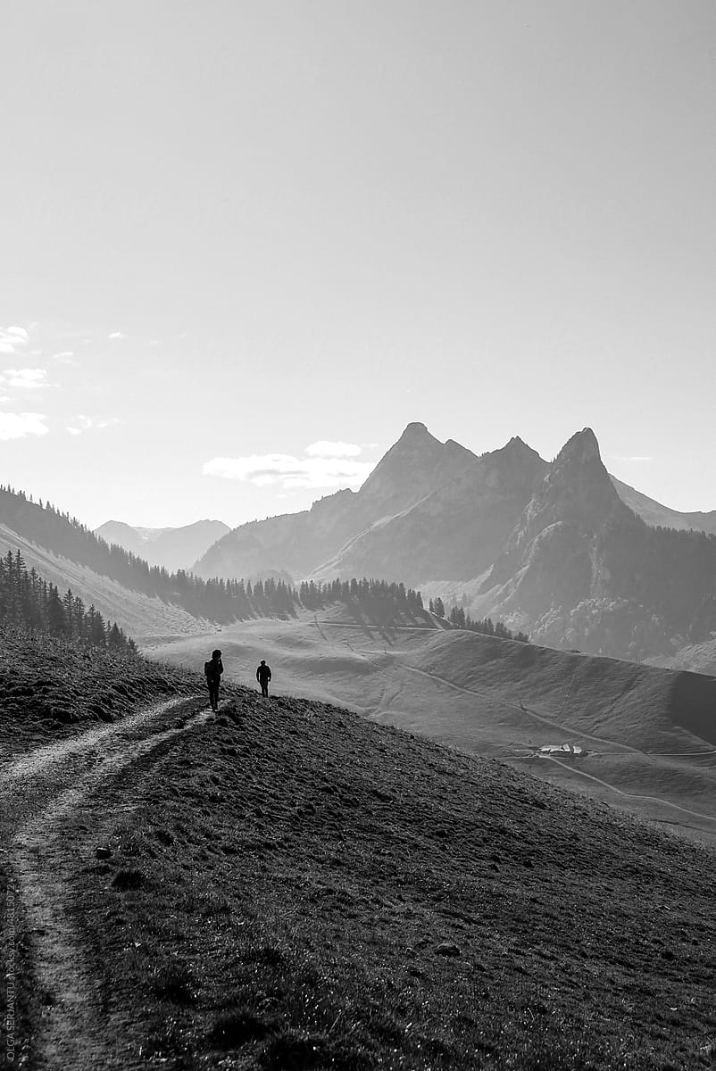 Impressive landscape, two people walking slowly on a path.