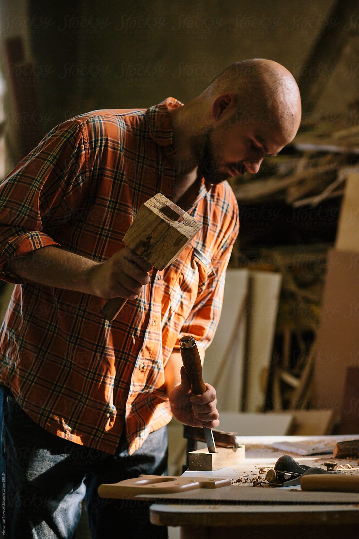 Young carpenter working in his workshop