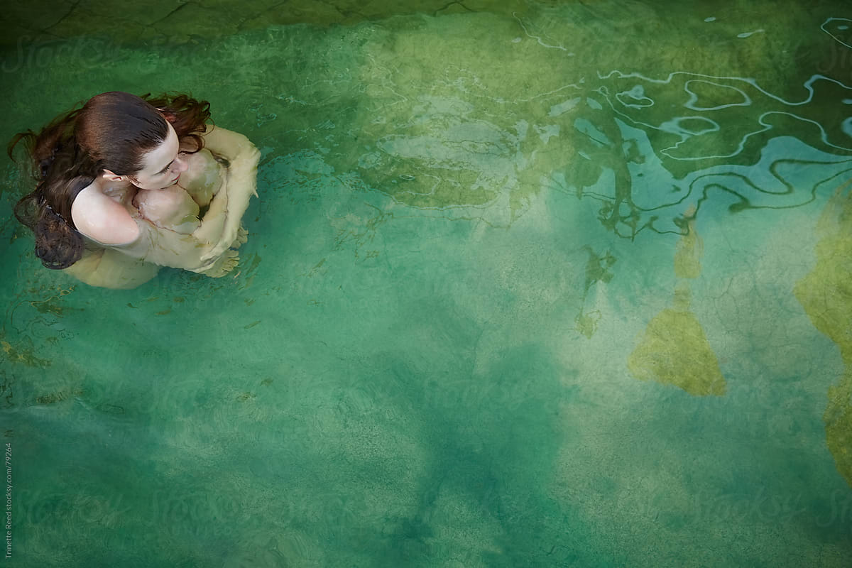 Woman relaxing in water at hot springs