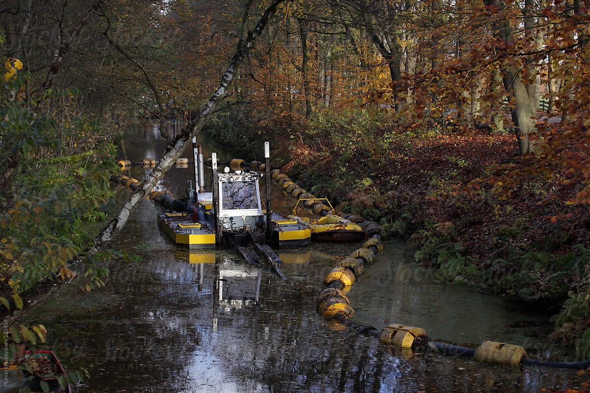 Dredge machine pumping mud out of a waterway