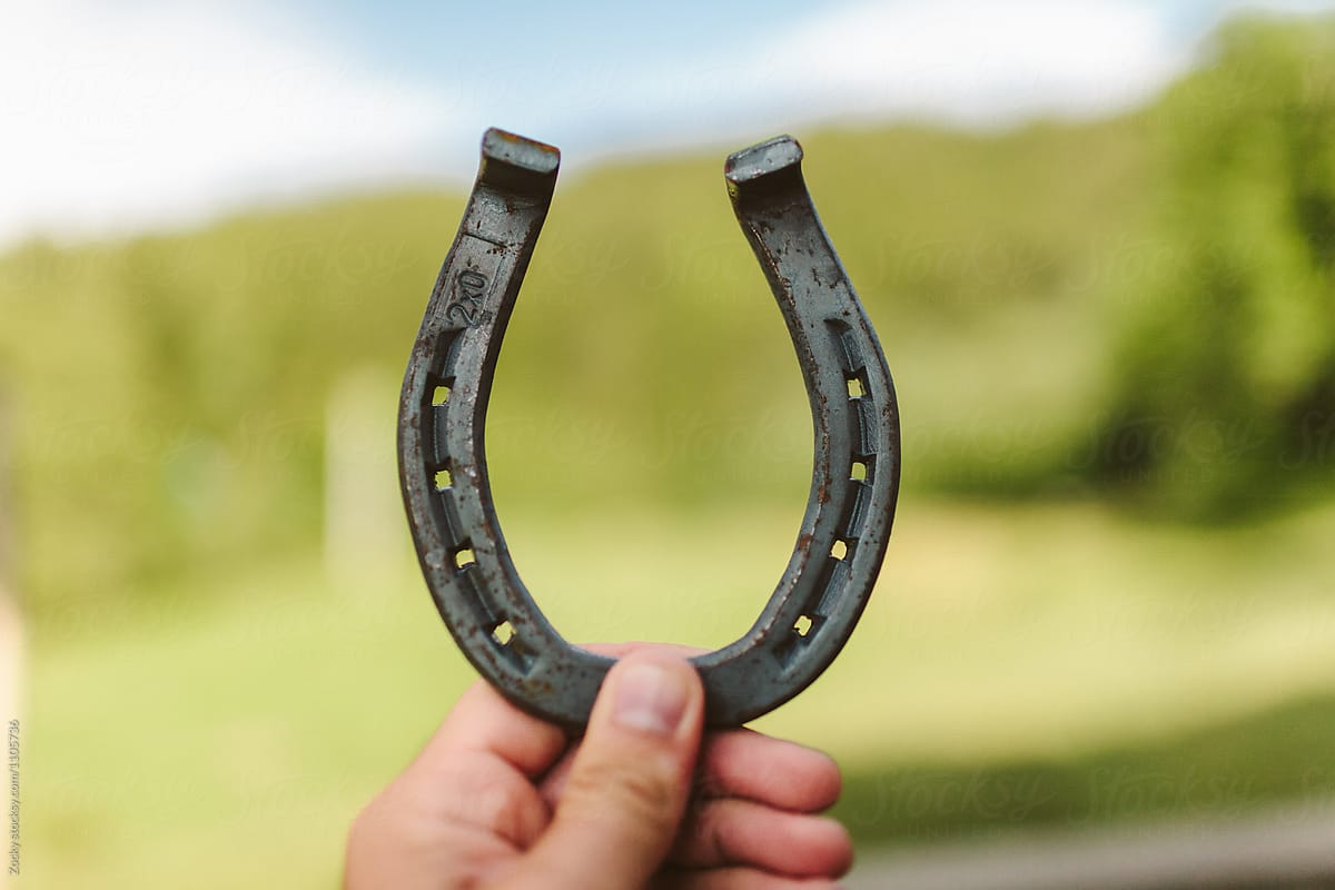 Hand holding horseshoe