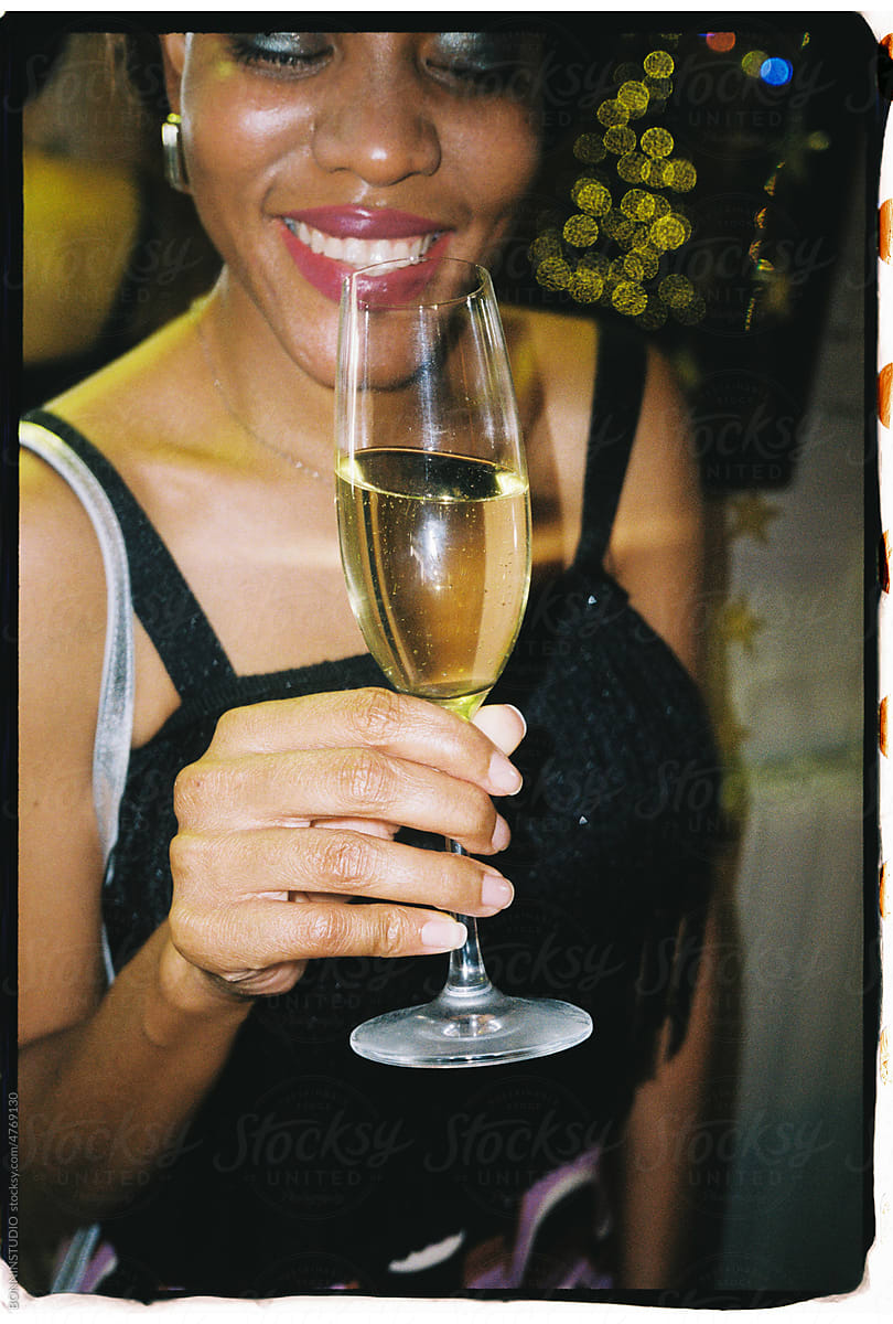 User generated content woman holding champagne glass and laughing