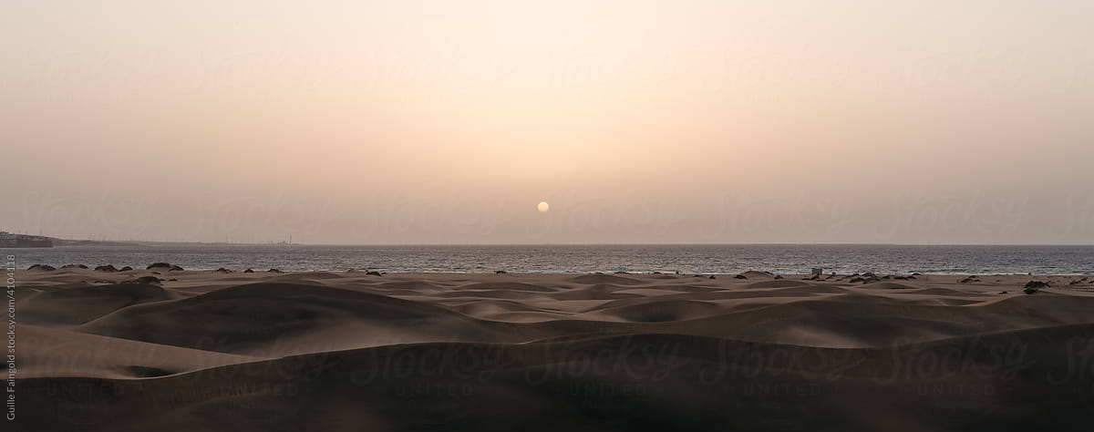 Sandy shoreline at sunset