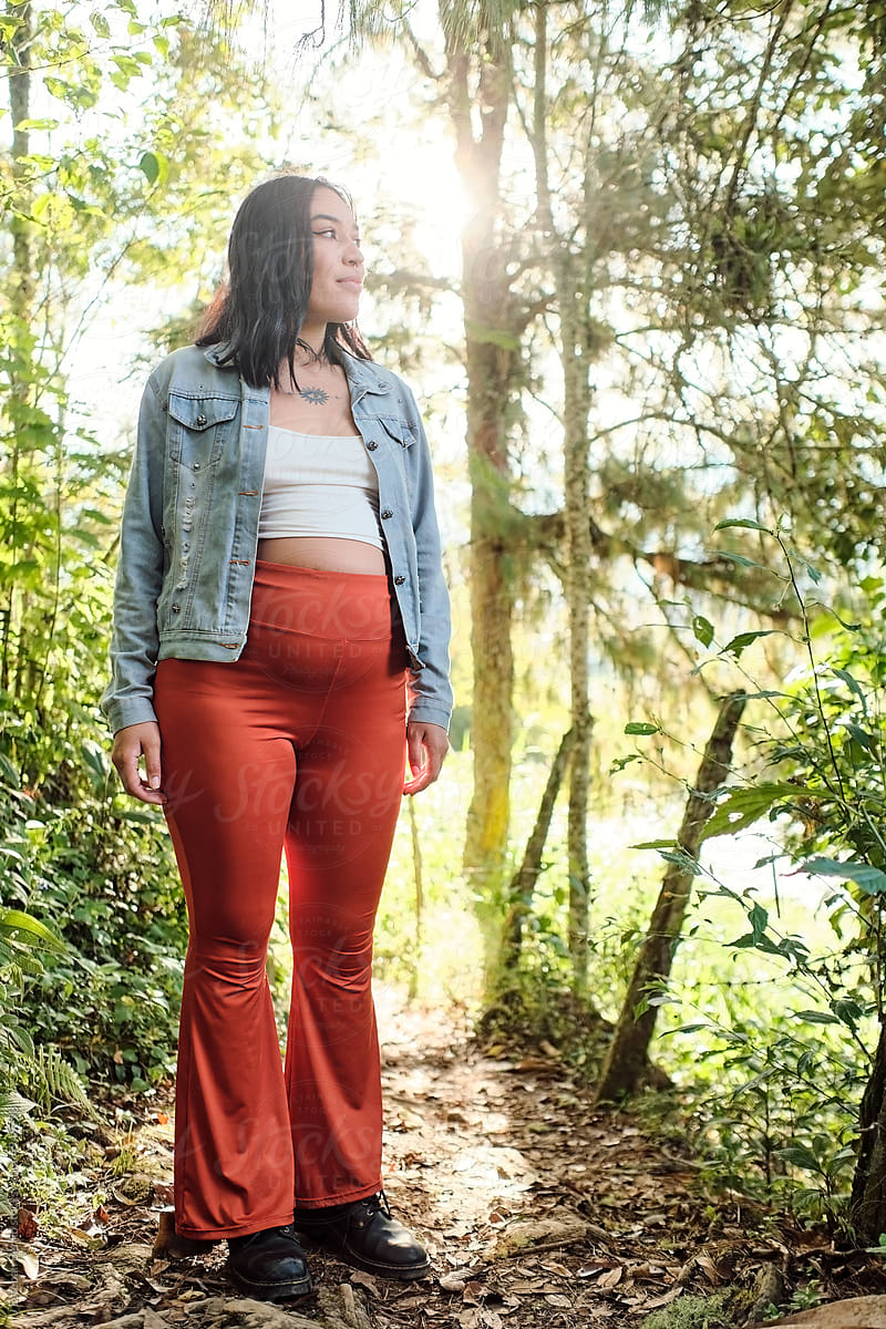 Young pregnant woman in the middle of a forest