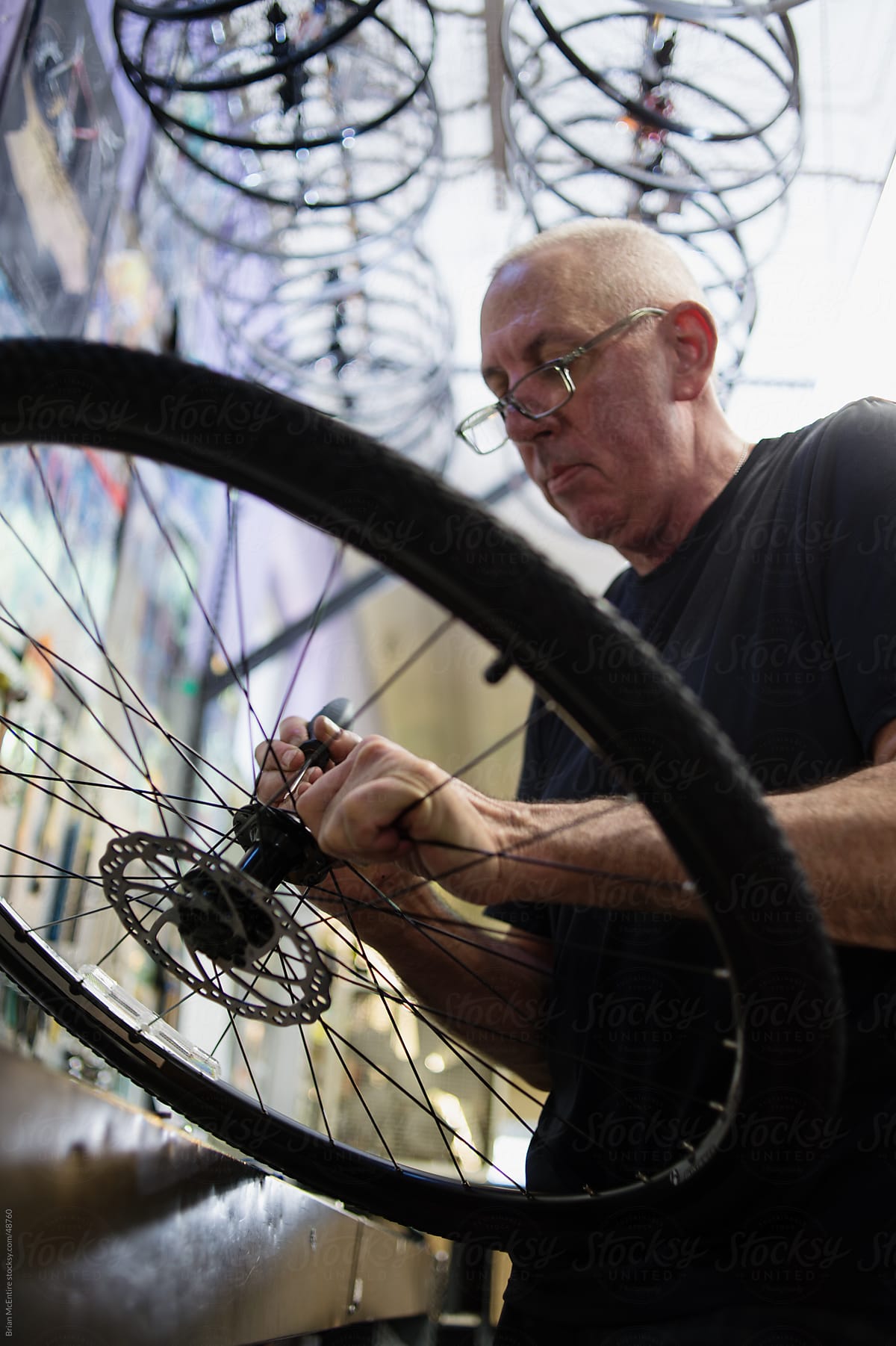 Local Bike Shop: Mechanic Adjusts Wheel Hub