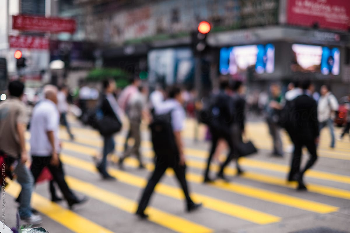 Pedestrians crossing a busy street in Hong Kong