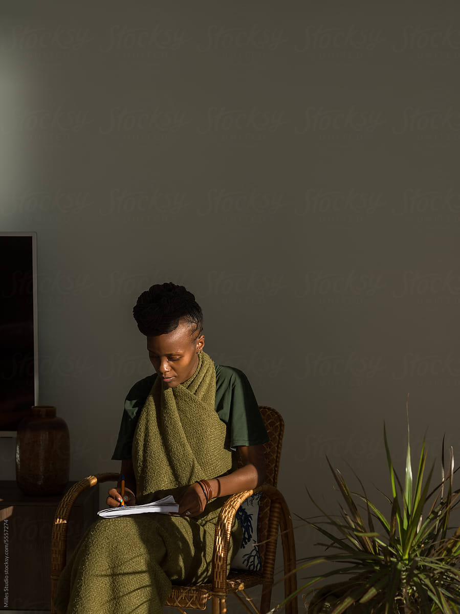 Young black woman studying in living room