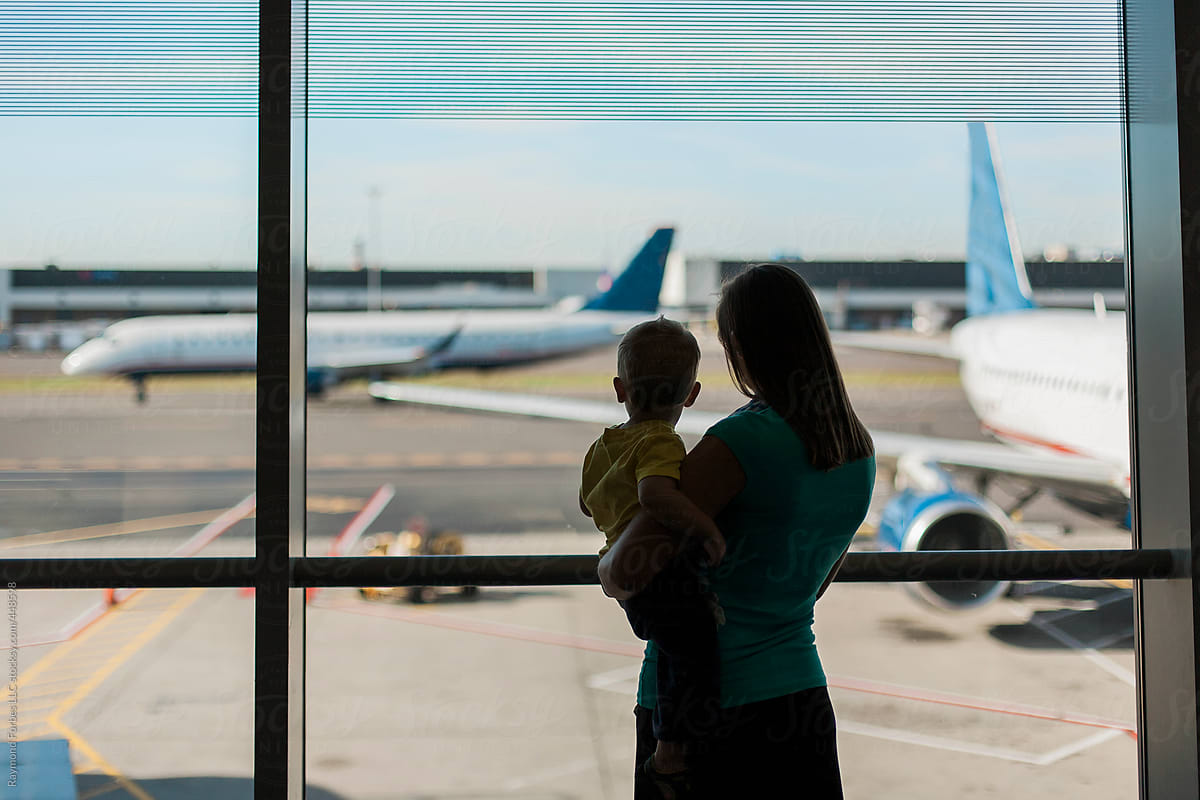 Mother and Child at Airport Waiting for Dads plane to arrive