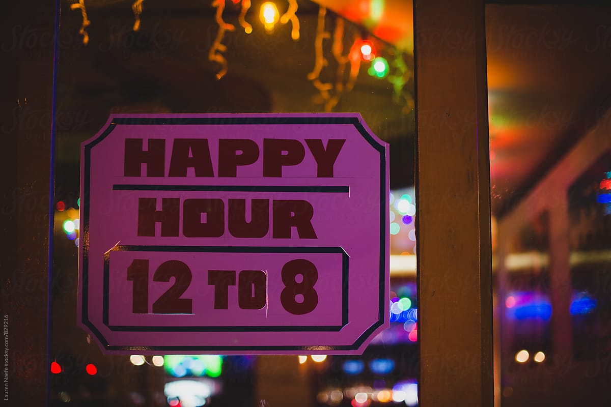 Happy hour sign at night