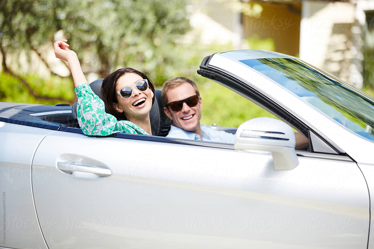 Beautiful couple going on road trip in convertible car