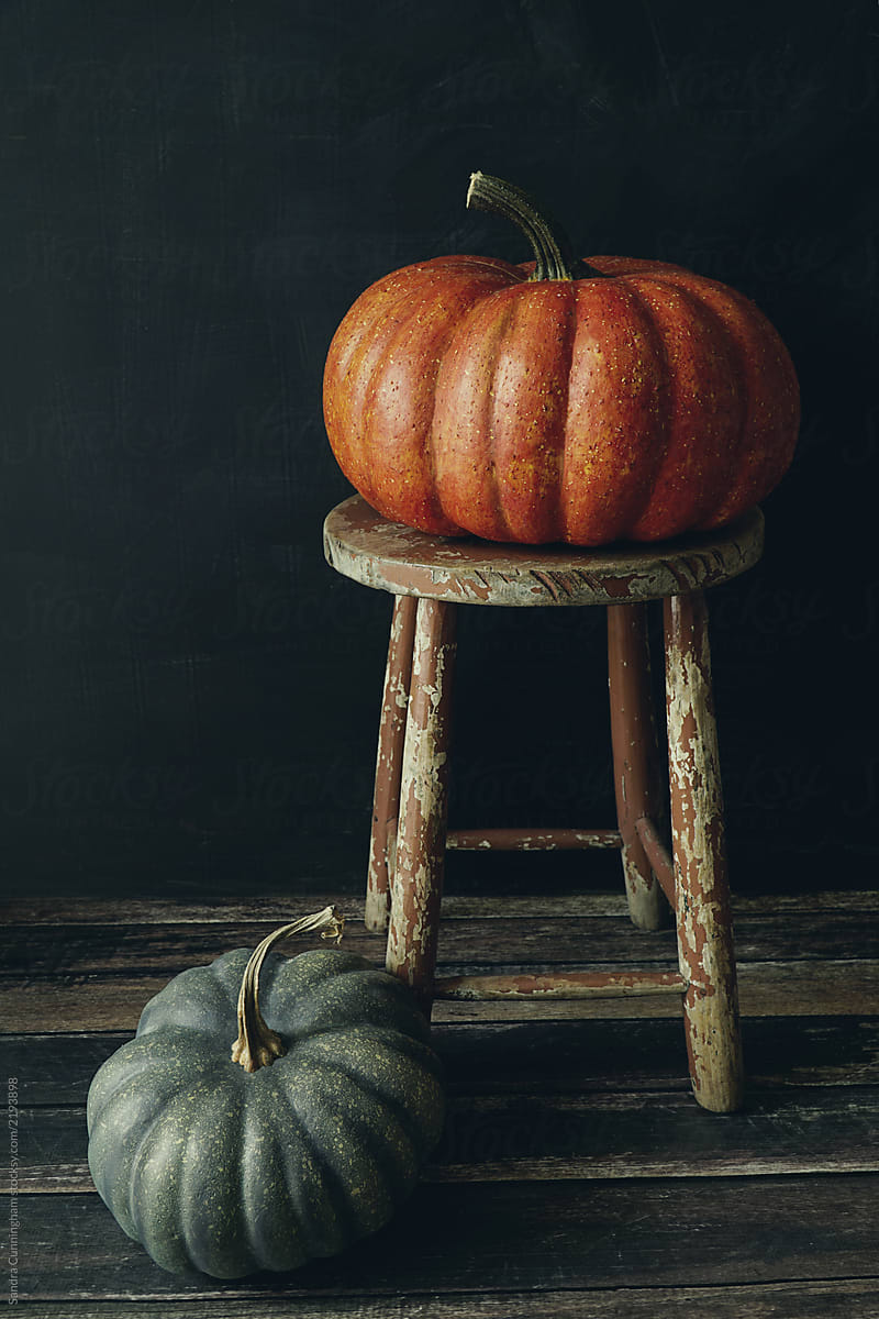 Colored pumpkins on wooden stool