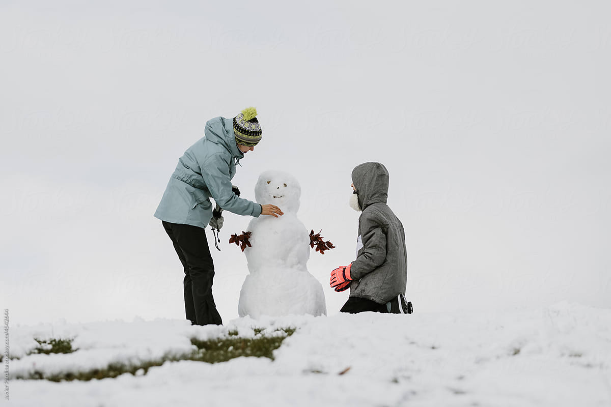 Mother and daughter with snowman