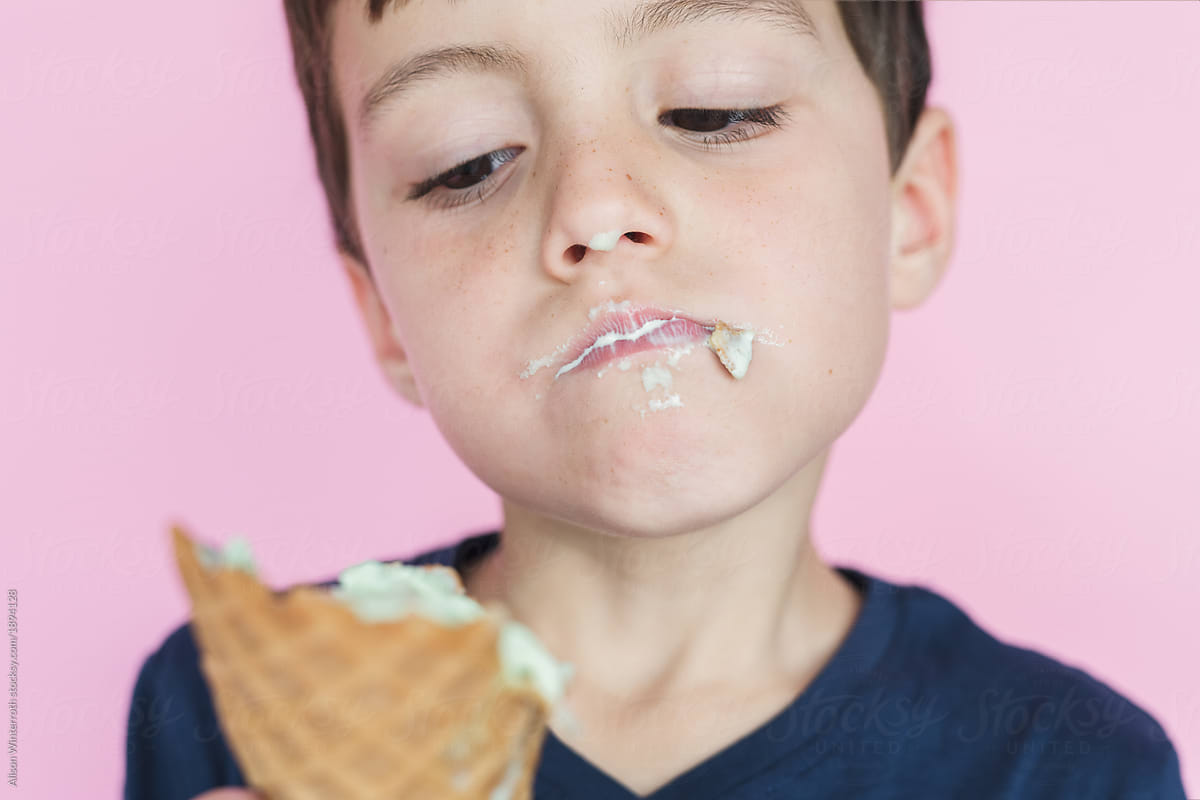 A Young Boy Eats Ice Cream Messily