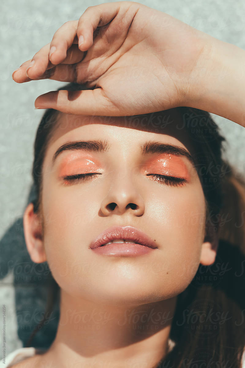 Sunlit face glow of woman beauty with closed eyes