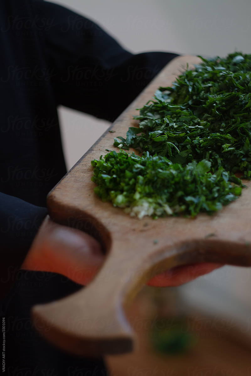 Wooden tray with chopped parsley, healthy food