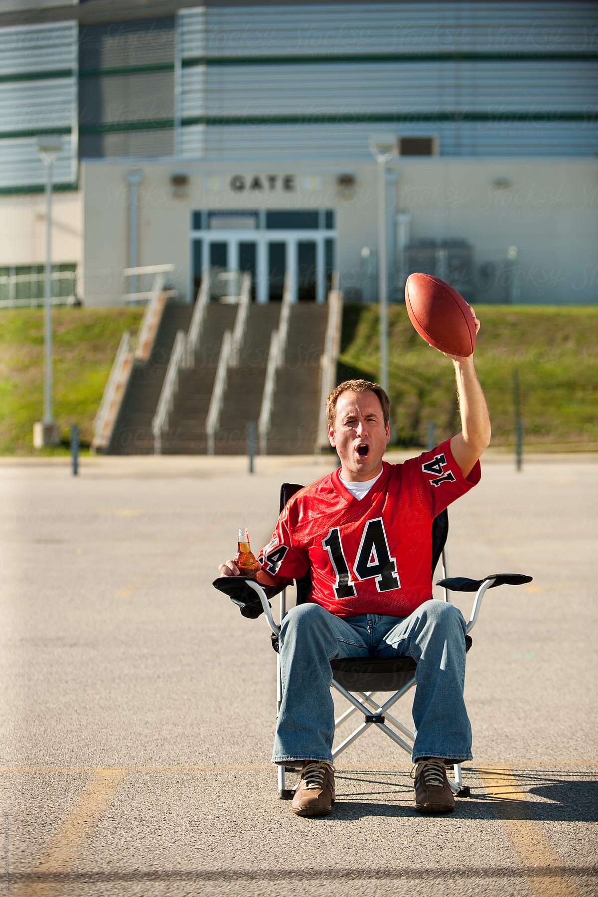 Tailgating: Fan Sits Alone in Lot Waiting for Game