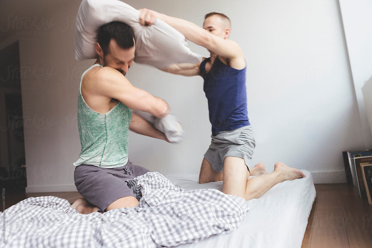 Gay Jock Lovers Playfully Horsing Around In Bed Having A Pillow Fight