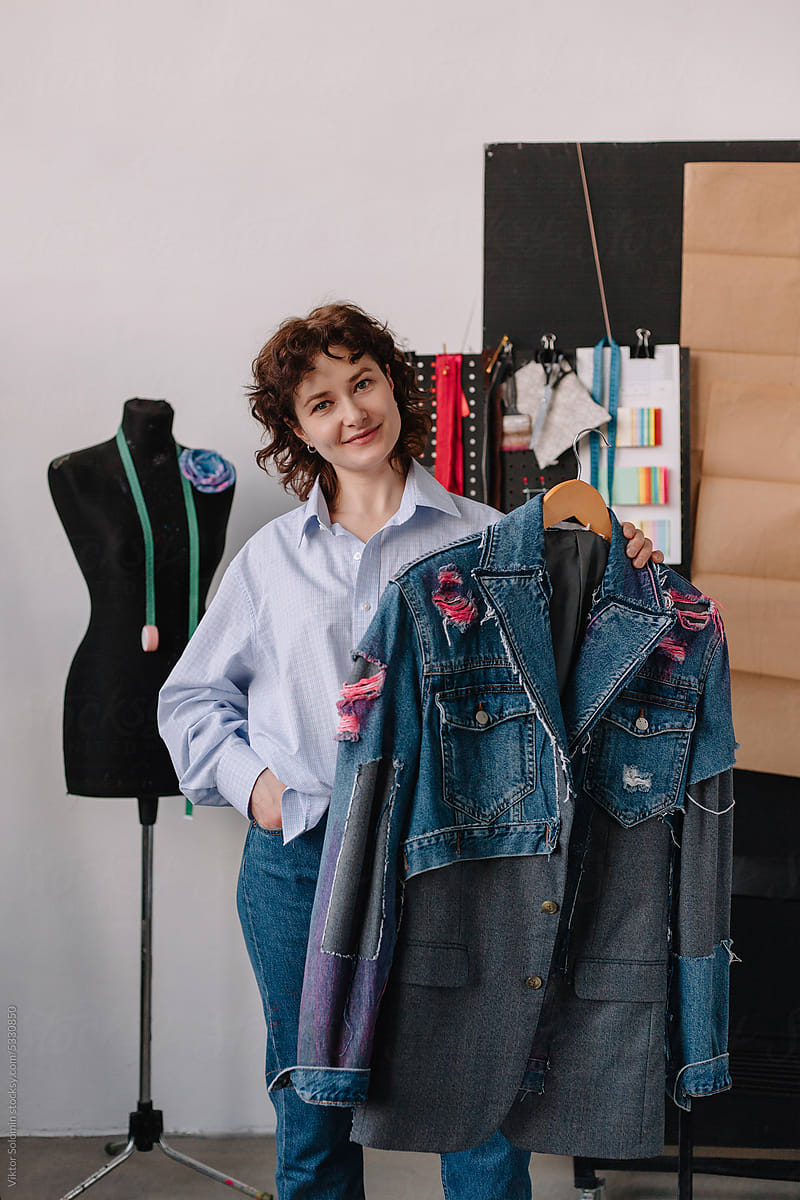 Stylish female designer showing upcycled denim jacket