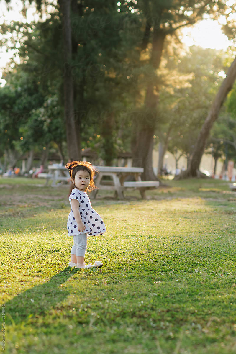 Little girl in the park making funny cute face