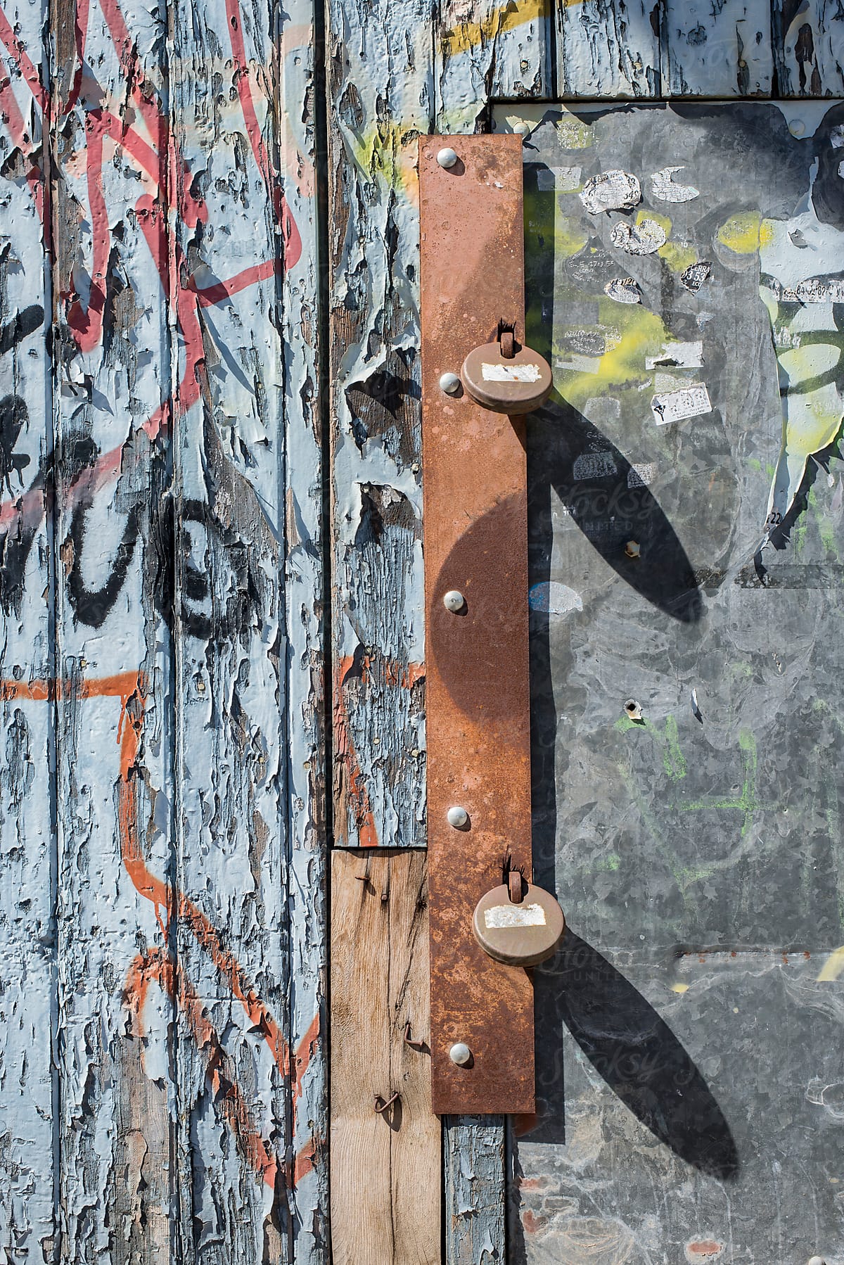 Rusty padlocks in shabby wooden wall