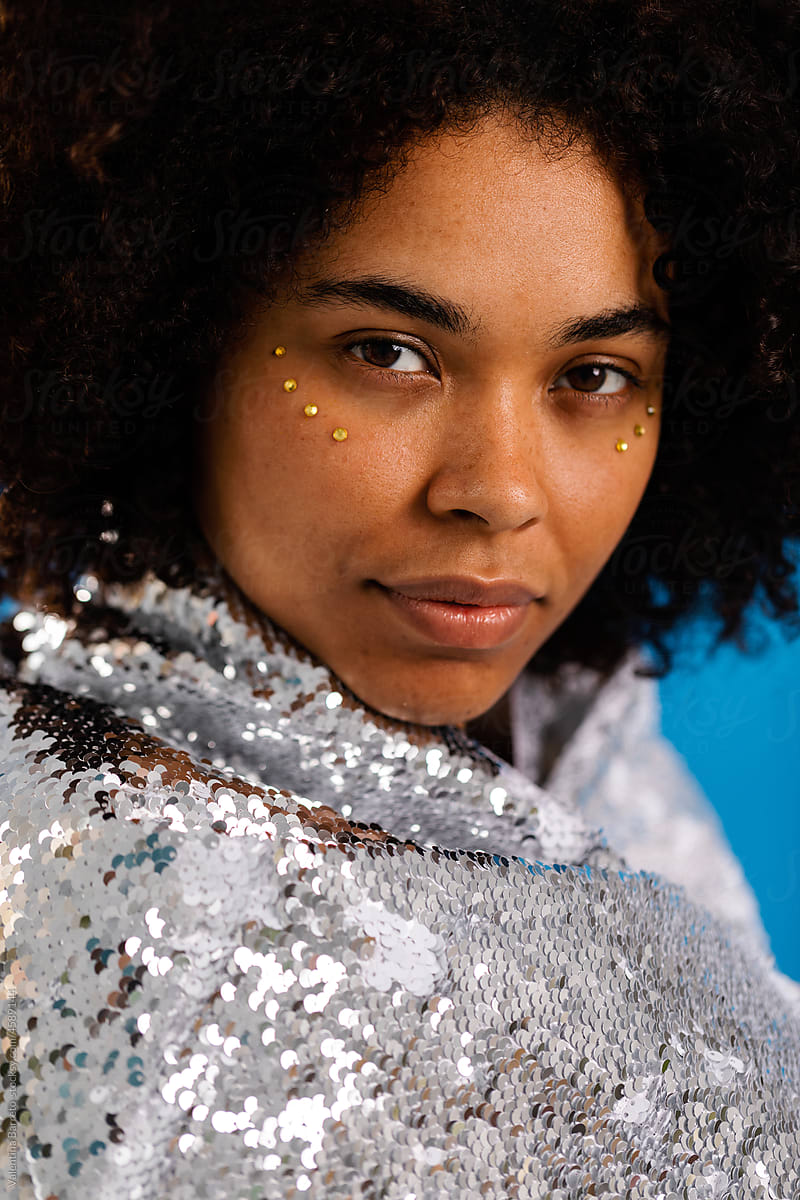 Latin woman posing with sequined fabric portrait
