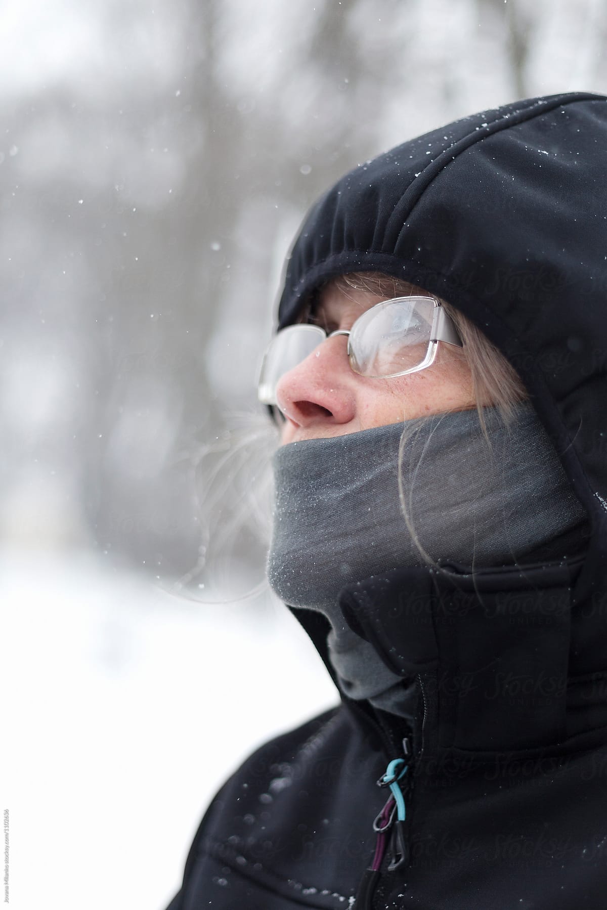Senior Woman Enjoying Snowfall Outdoors
