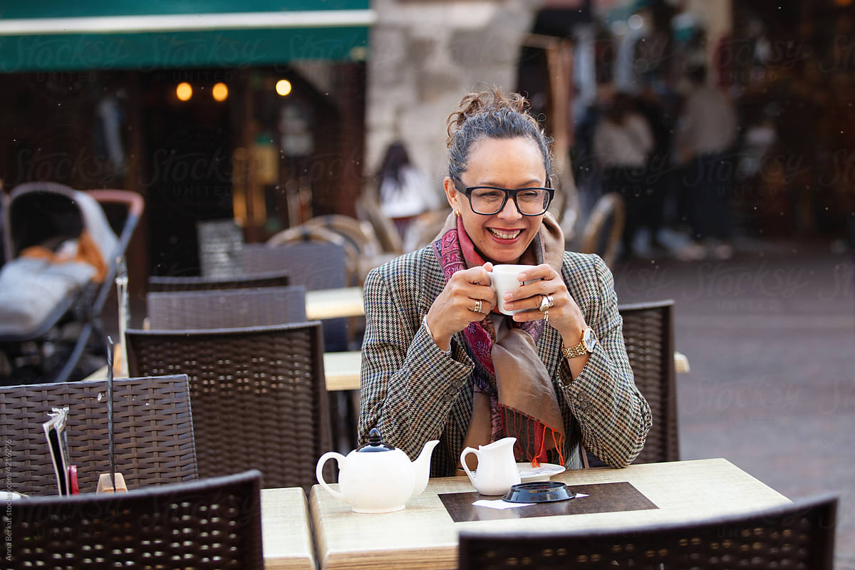 mature business woman laughing in cafe