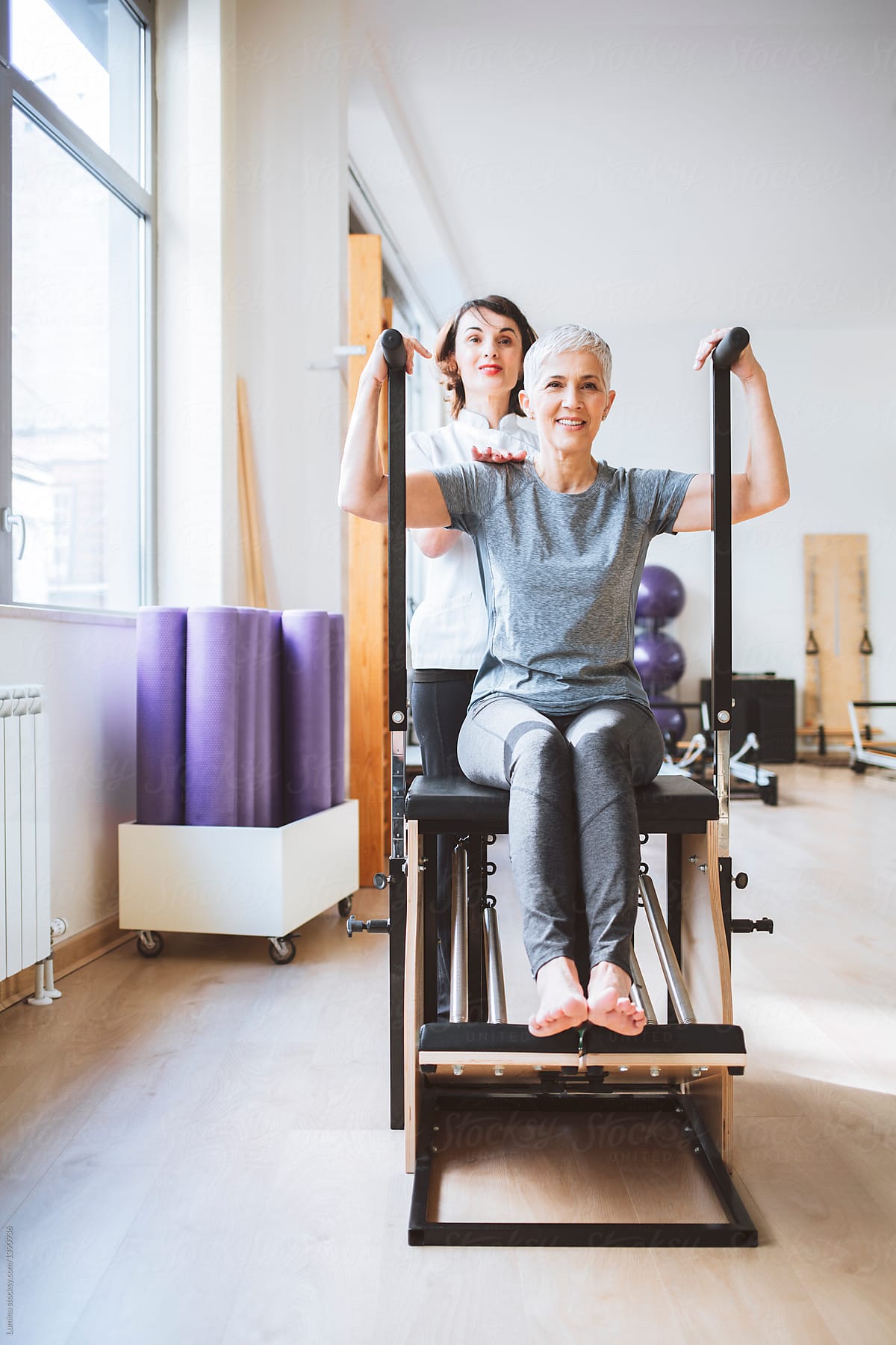 Woman Doing Back Exercise With Therapist By Stocksy Contributor