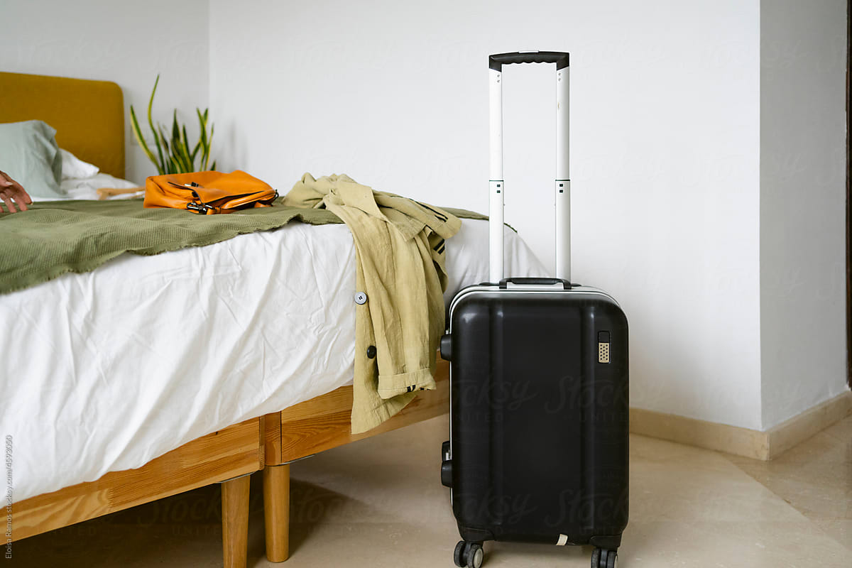 Wheeled suitcase in bedroom