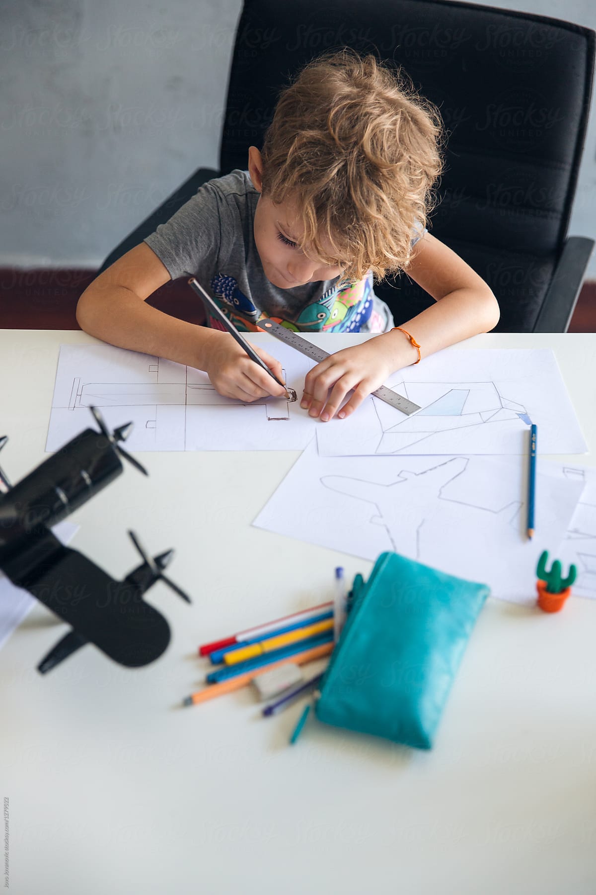 Boy drawing an airplane