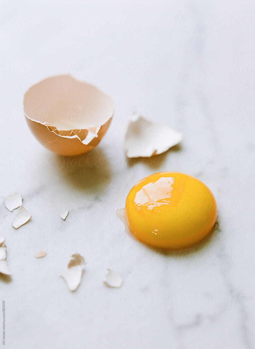 Close up of cracked organic egg yolk and shell