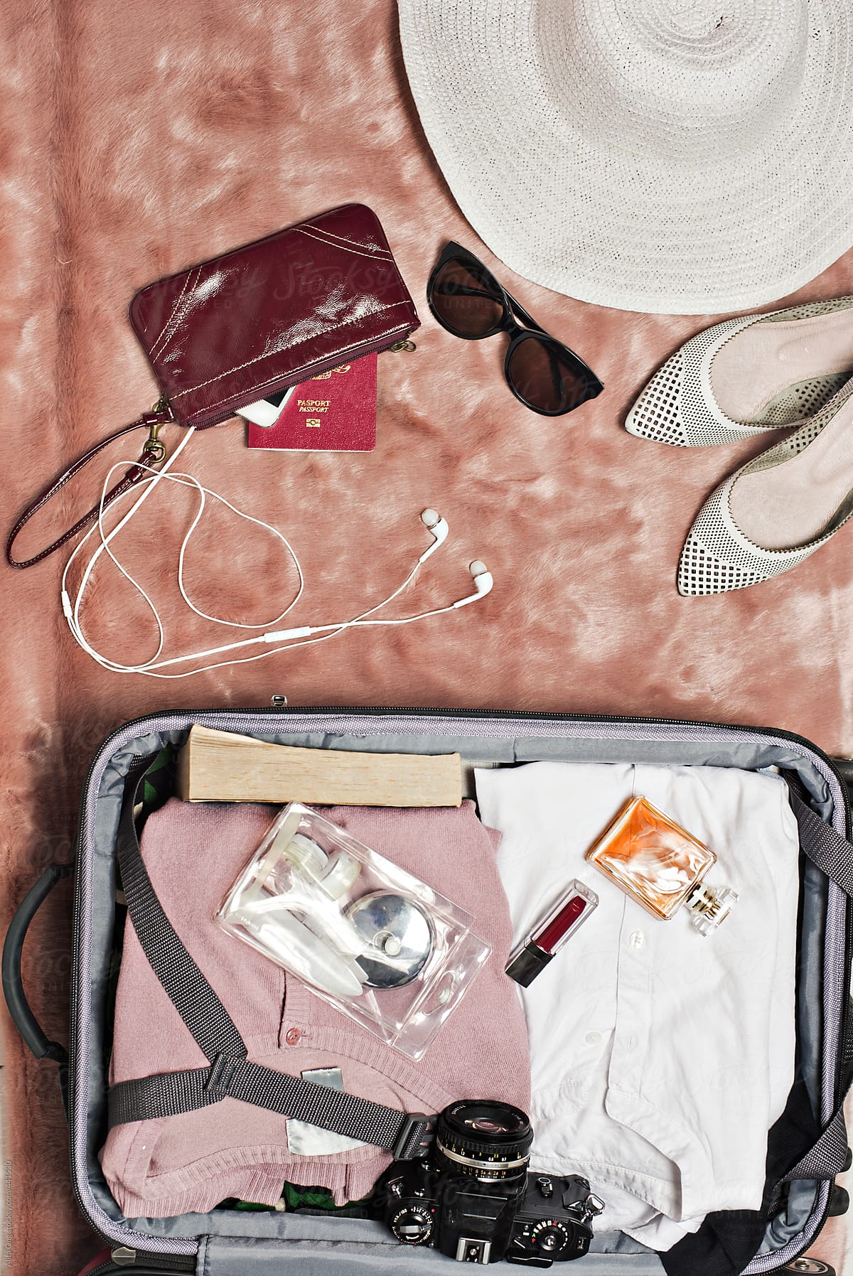 Woman Packing A Suitcase For A Trip by Stocksy Contributor Alita