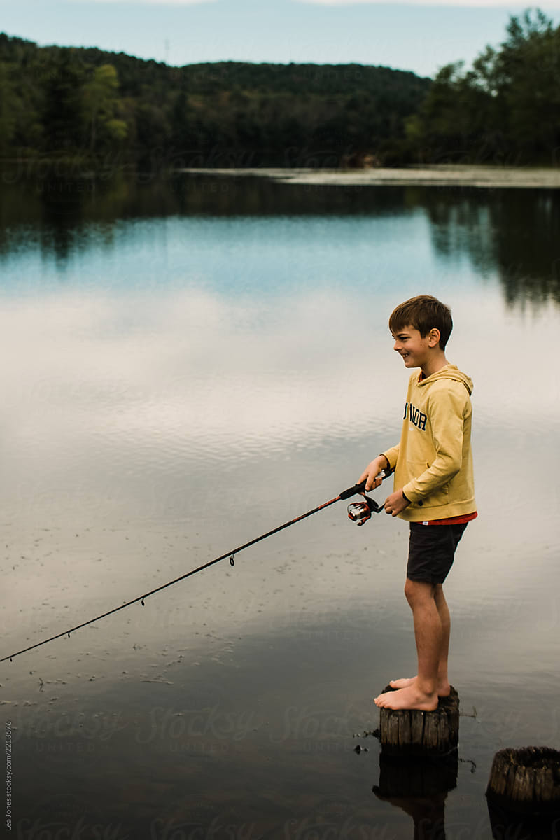 Boy Fishing On A Lake» del colaborador de Stocksy «Lea Jones