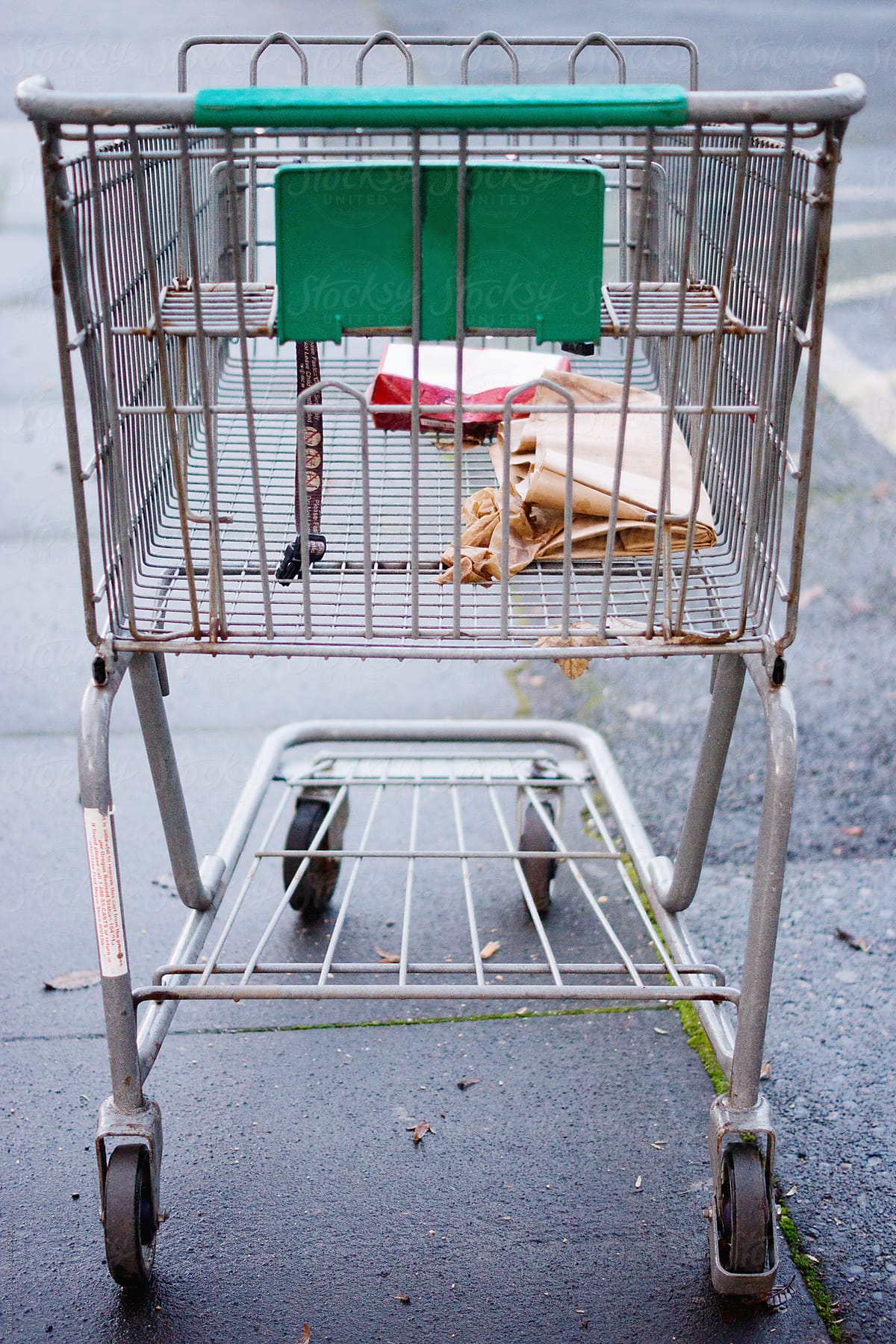 Abandoned shopping cart with litter left in it