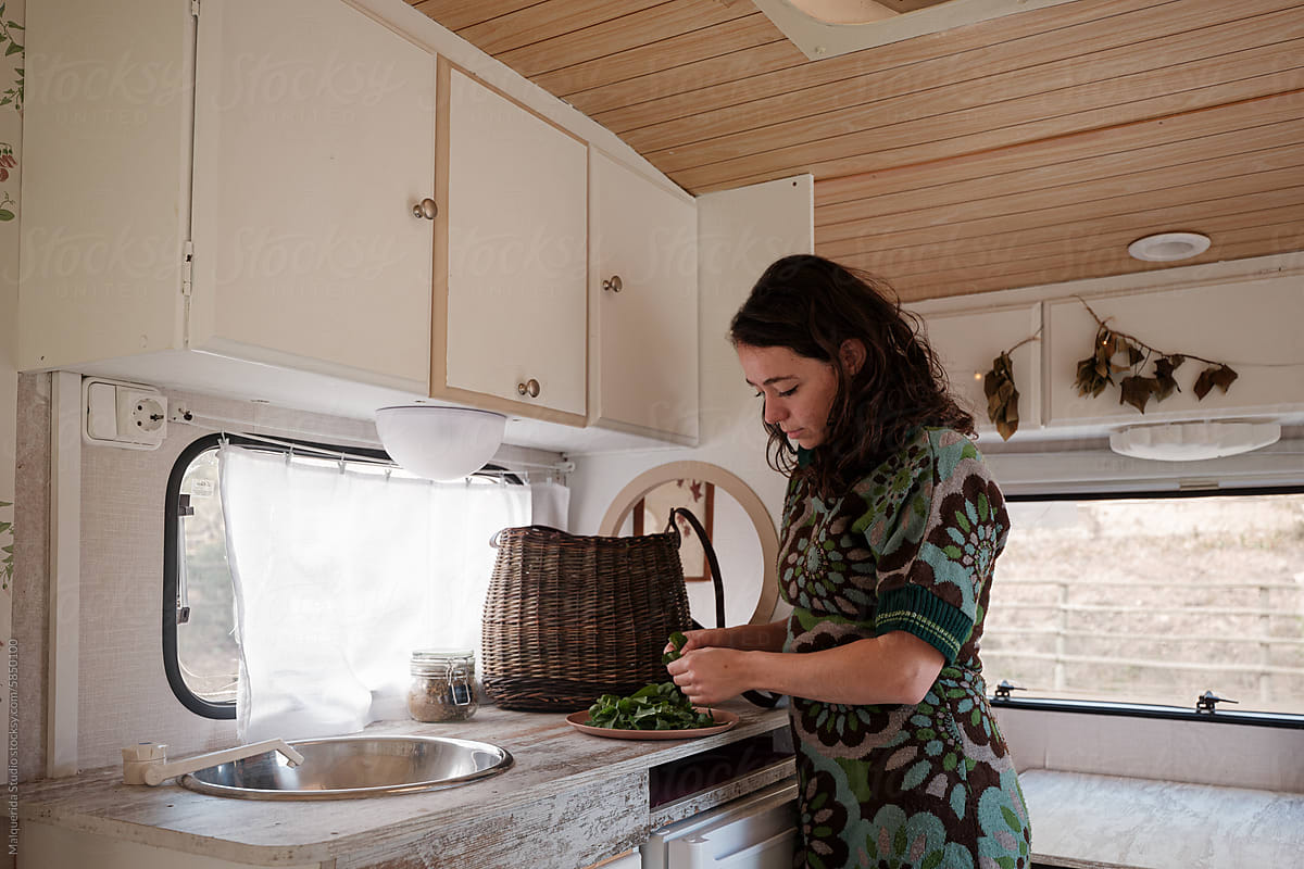 woman preparing meal in a caravan