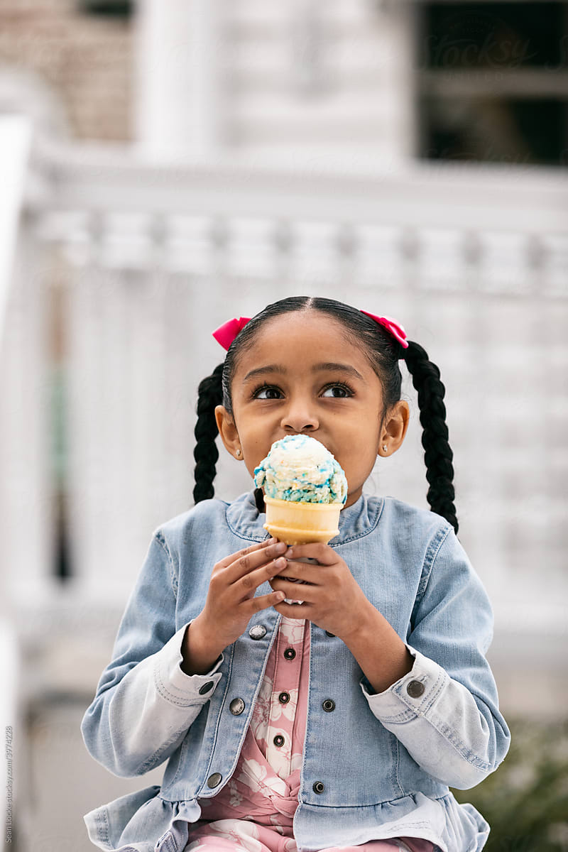 Young Girl Enjoying Eating An Ice Cream Cone