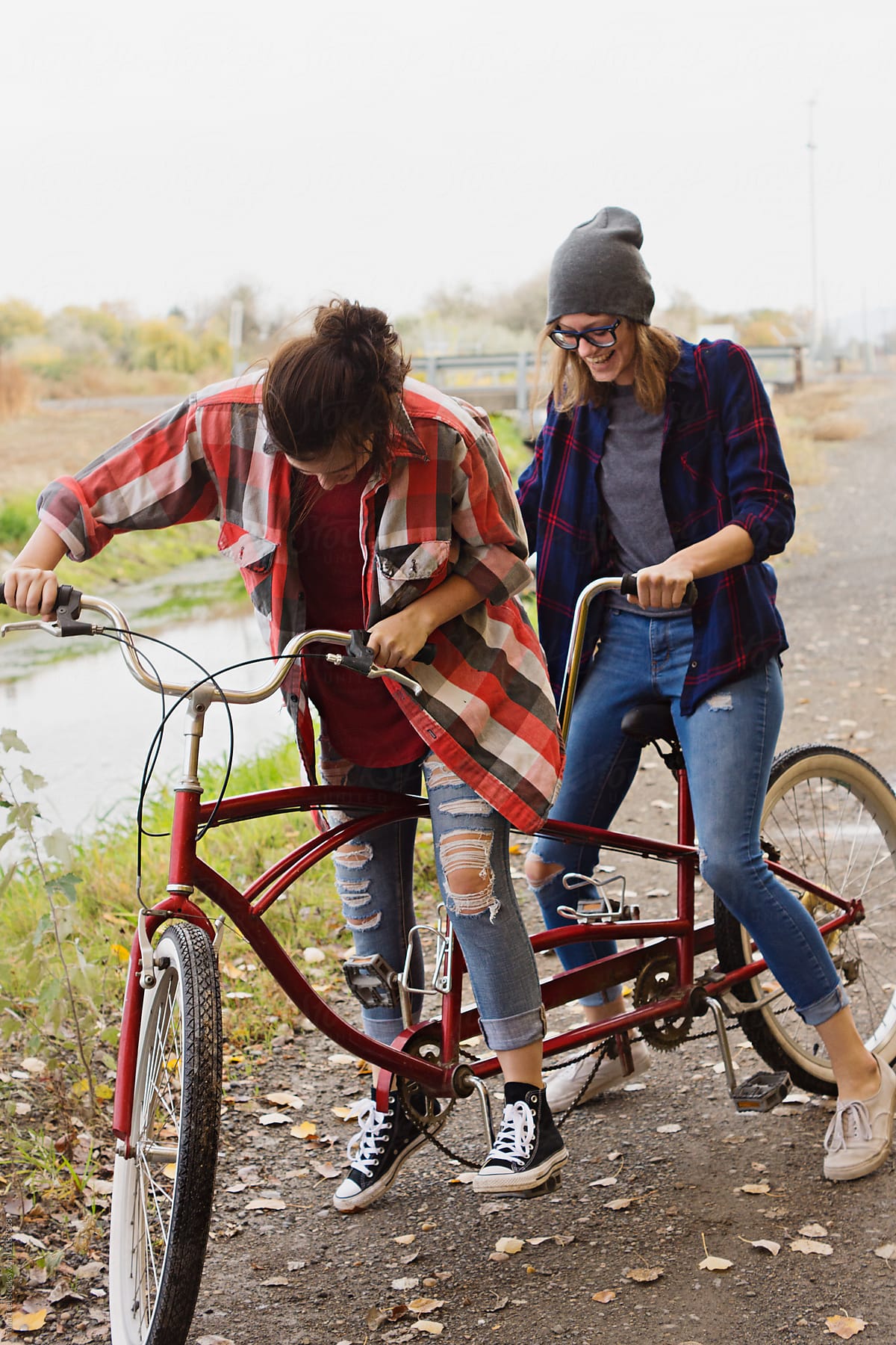 teen friends learn to ride tandem bike
