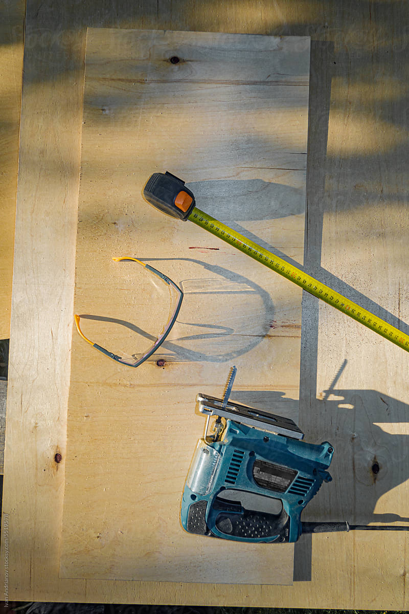 Plywood Workspace With Tools In Sunlight Outside