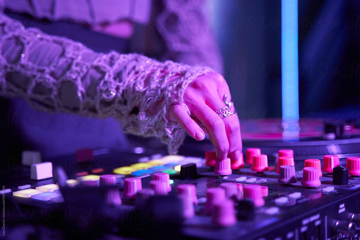 Female DJ turning switches on console