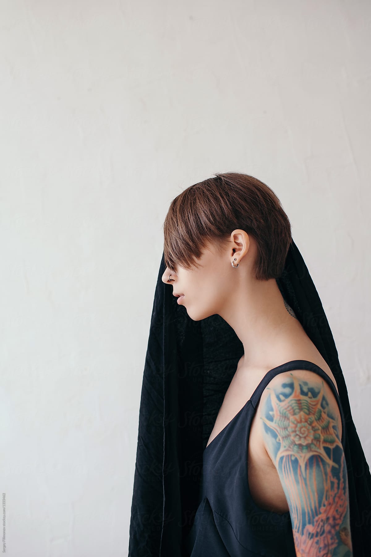 Fashion portrait of woman with tattoo wearing black clothes
