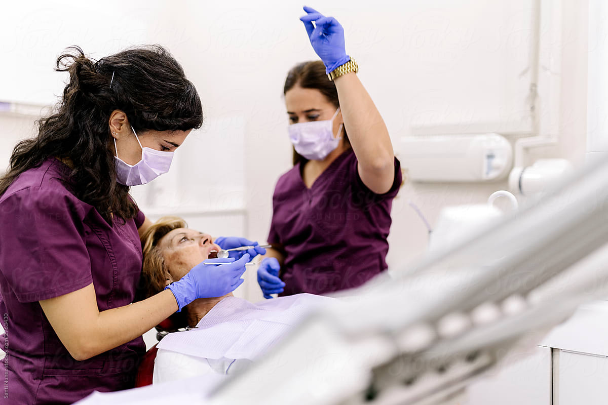 Dentists during a dental intervention with a patient.