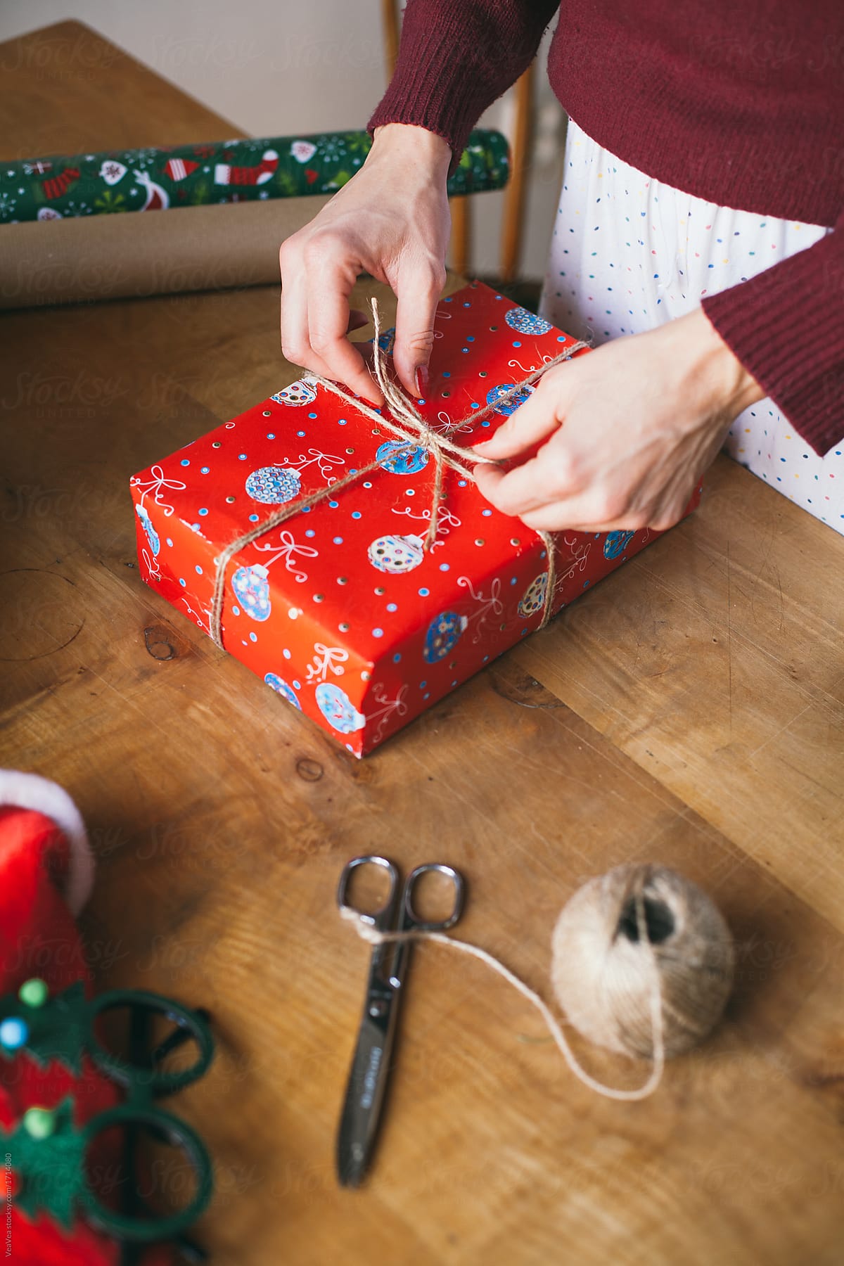 Woman wrapping Christmas presents indoor