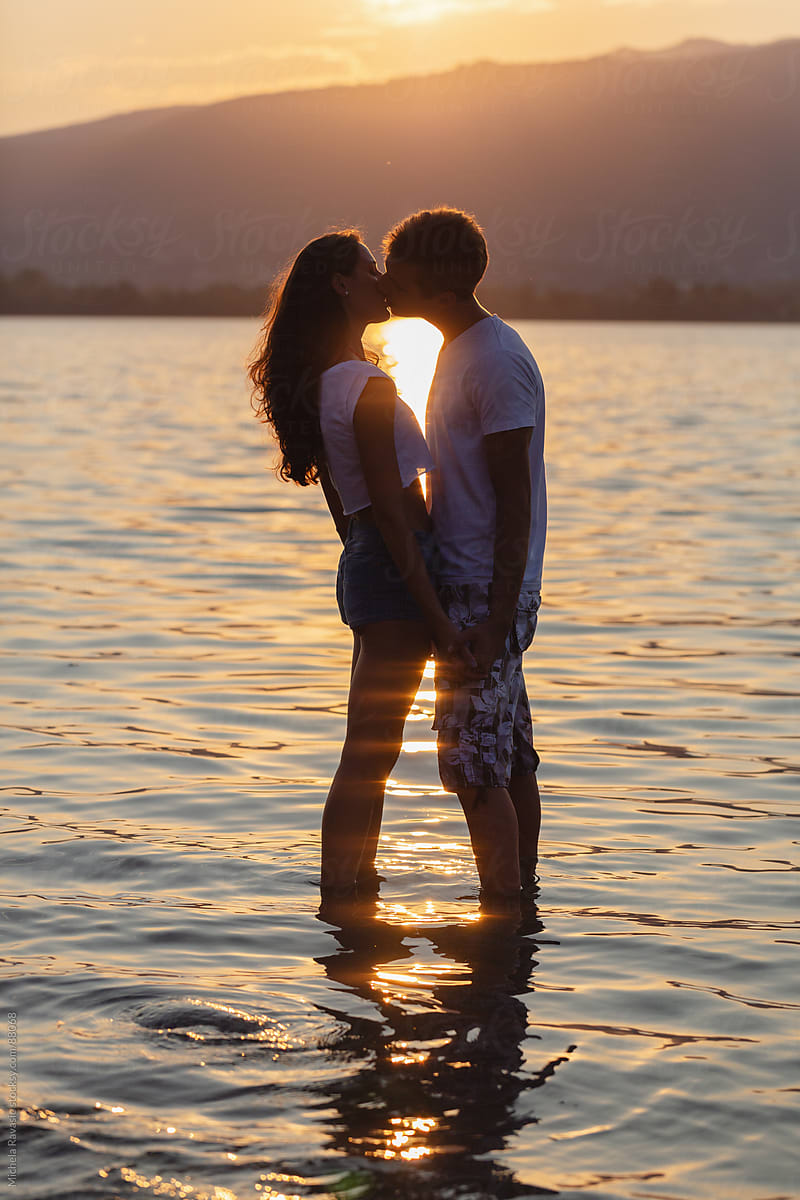 Couple Kissing In The Lake By Stocksy Contributor Michela Ravasio Stocksy 