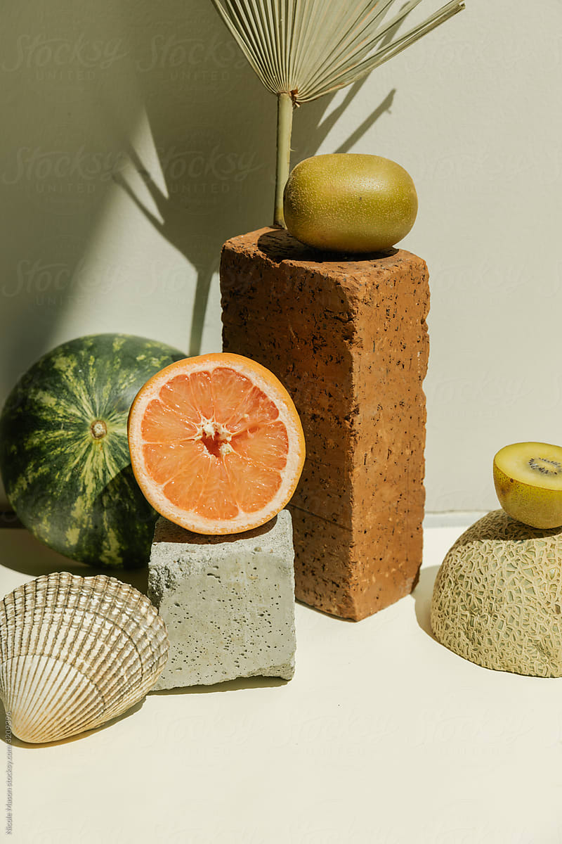 styled still life of fruit and textures in bright studio