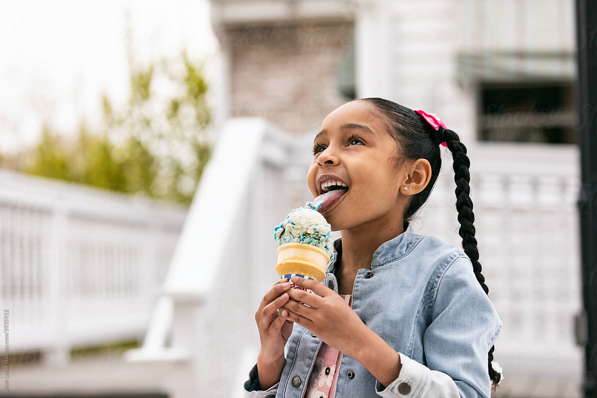 Young Girl Licking An Ice Cream Cone
