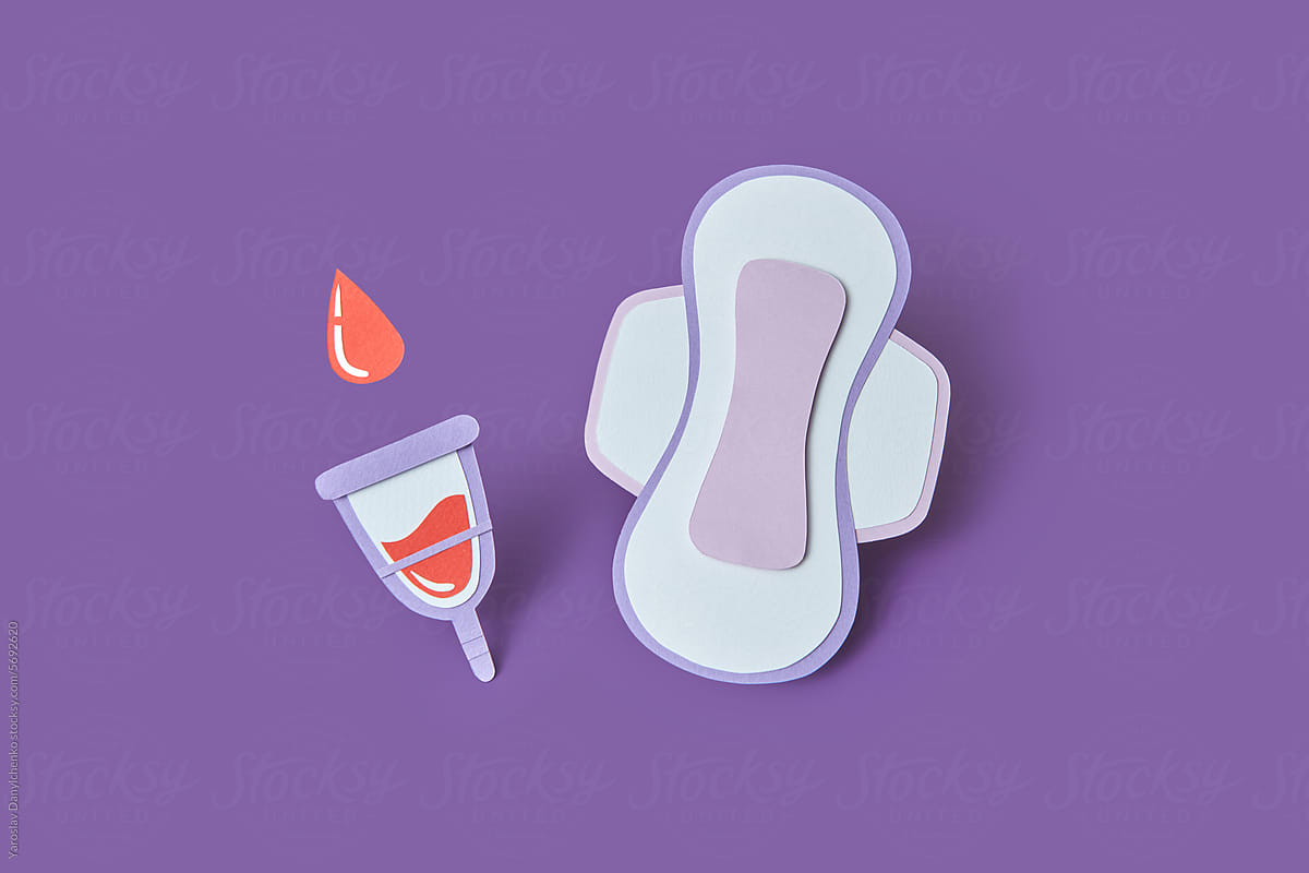 Paper artwork of sanitary pad and menstrual cup filled with blood