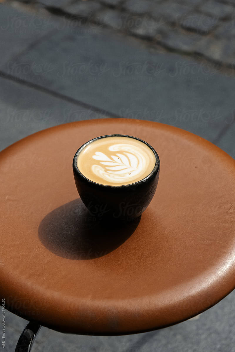 Close up of a coffee cup with latte art decorations